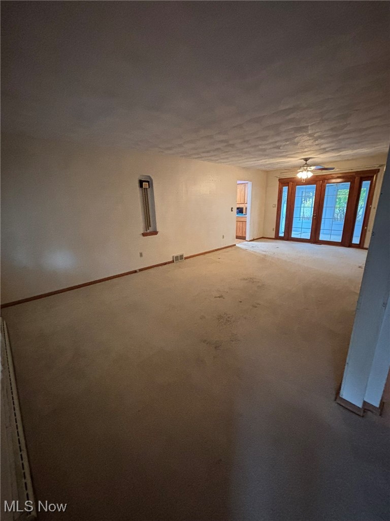 1039 Center Road Eastlake, OH 44095 - Photo 4 of 29 Living room with ceiling fan and original hardwood floors under carpet