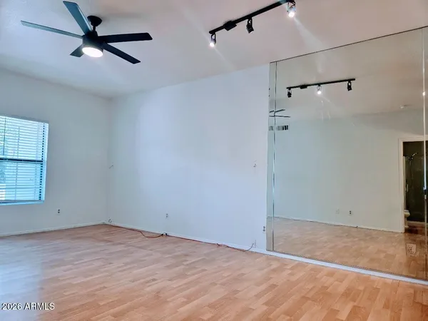 a large kitchen with stainless steel appliances a large counter top a refrigerator and a sink