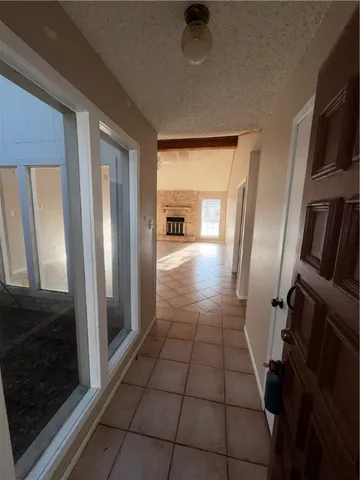 a view of a hallway to a livingroom with furniture