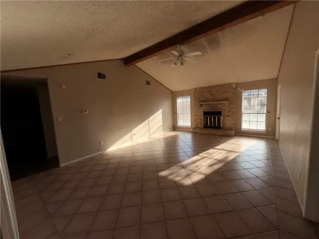 a view of empty room with a fireplace