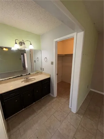 a spacious bathroom with a double vanity sink and a mirror