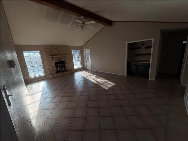 a view of an empty room with a fireplace