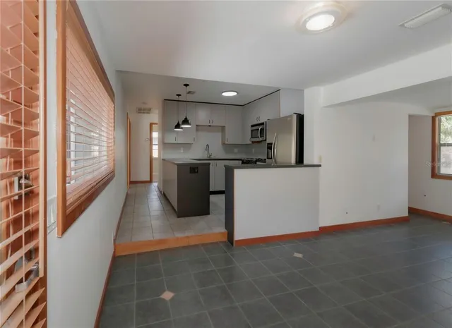 a kitchen with stainless steel appliances a sink stove and cabinets