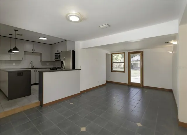 a view of a kitchen and a sink cabinet windows and a kitchen