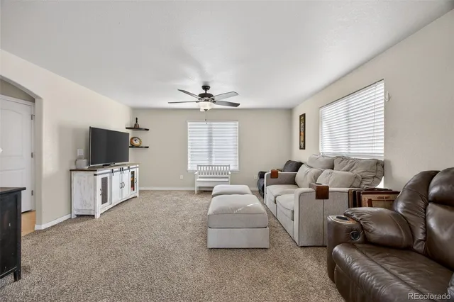 a view of a hallway with dining room and wooden floor
