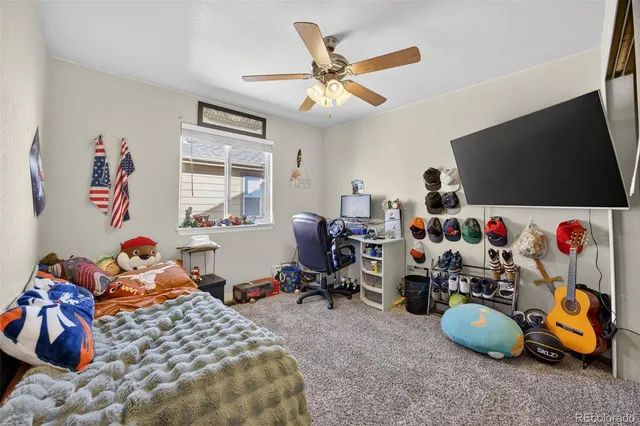 a bedroom with a bed and a painting on the wall