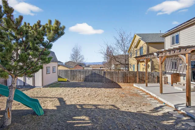a spacious bathroom with a granite countertop sink a toilet a mirror and shower