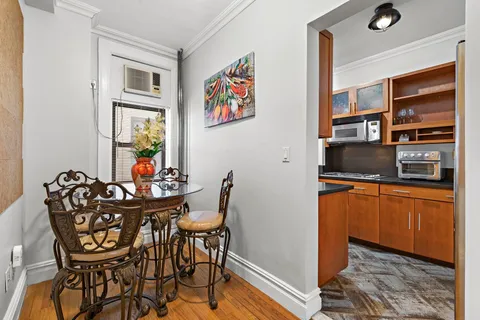 a dining room with furniture and window