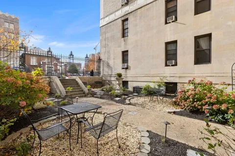 a view of a patio with table and chairs and potted plants