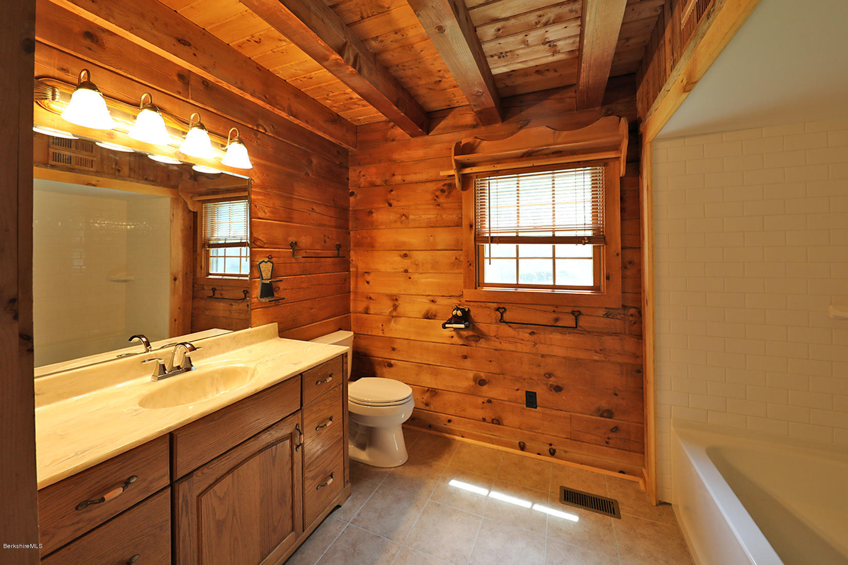 71 North Washington State Road Washington, MA 01223 - Photo 14 of 18 a bathroom with a double vanity sink toilet mirror and tub