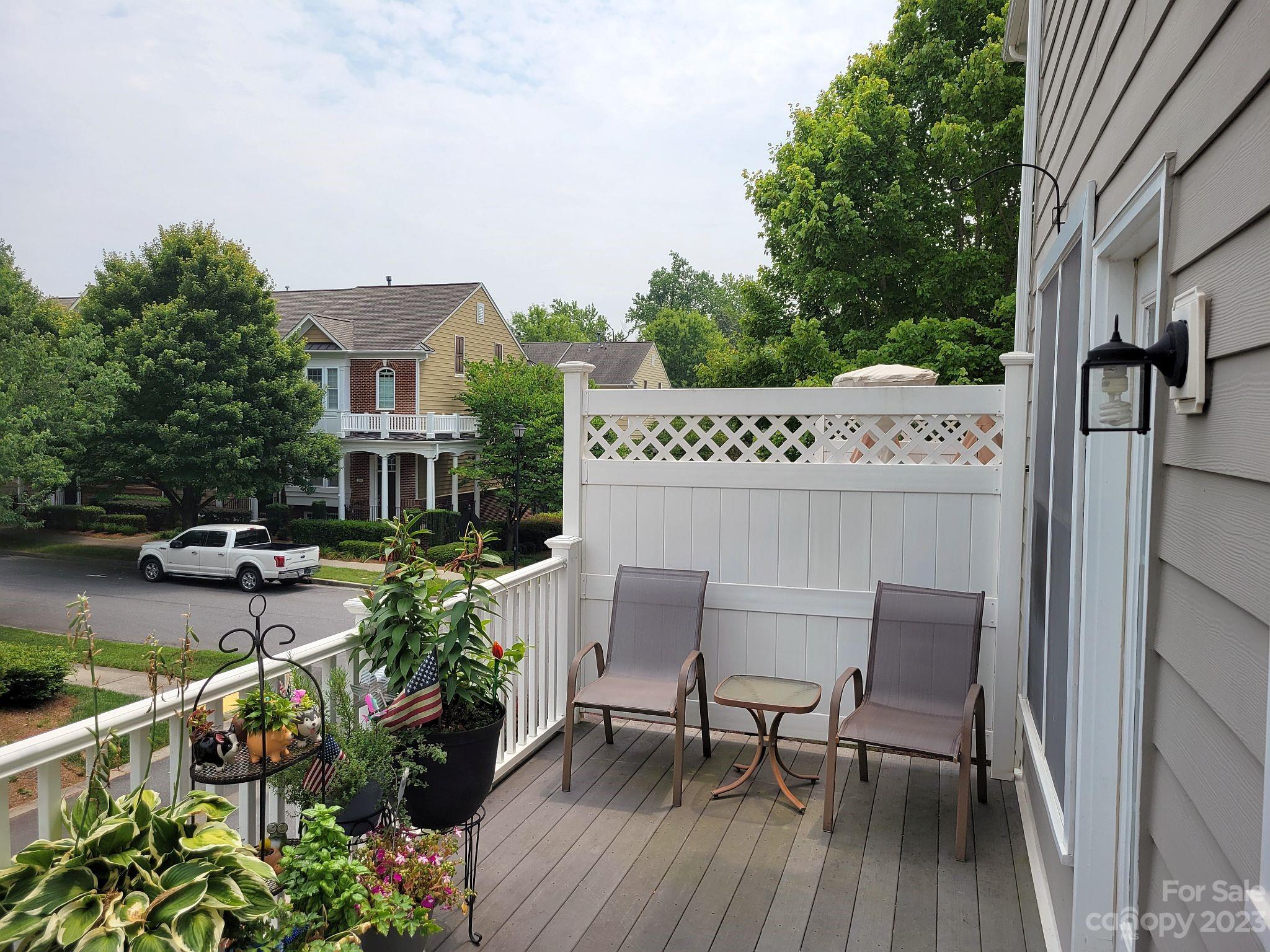 649 6th Baxter Crossing Fort Mill, SC 29708 - Photo 17 of 32 a view of a patio with table and chairs and potted plants