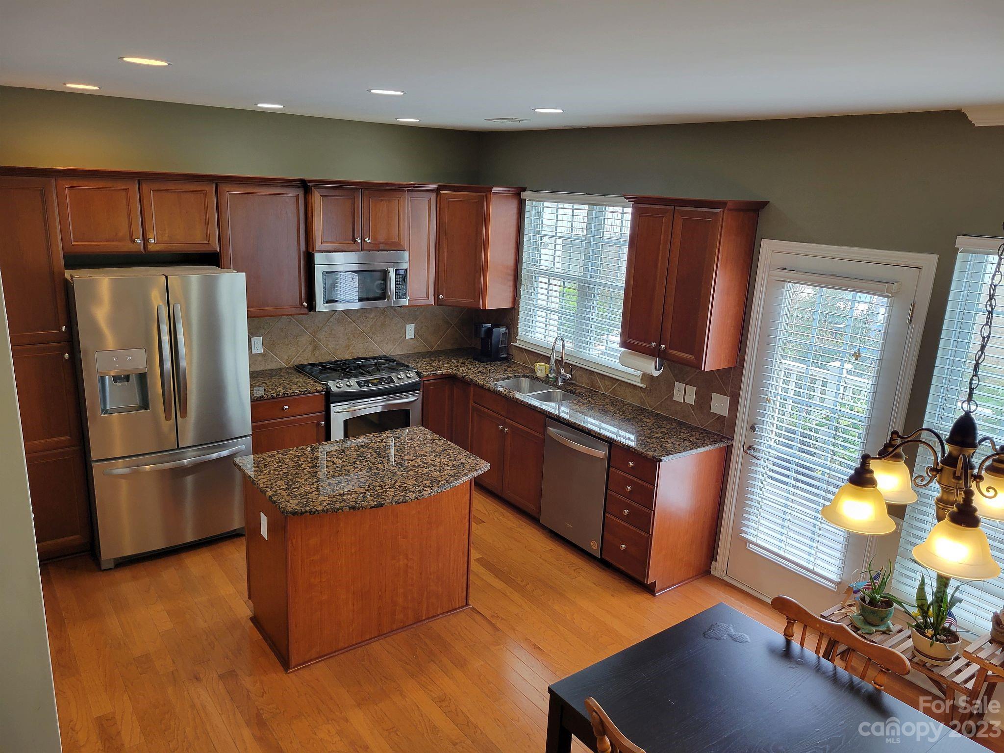 649 6th Baxter Crossing Fort Mill, SC 29708 - Photo 9 of 32 a kitchen with stainless steel appliances granite countertop a refrigerator stove and oven