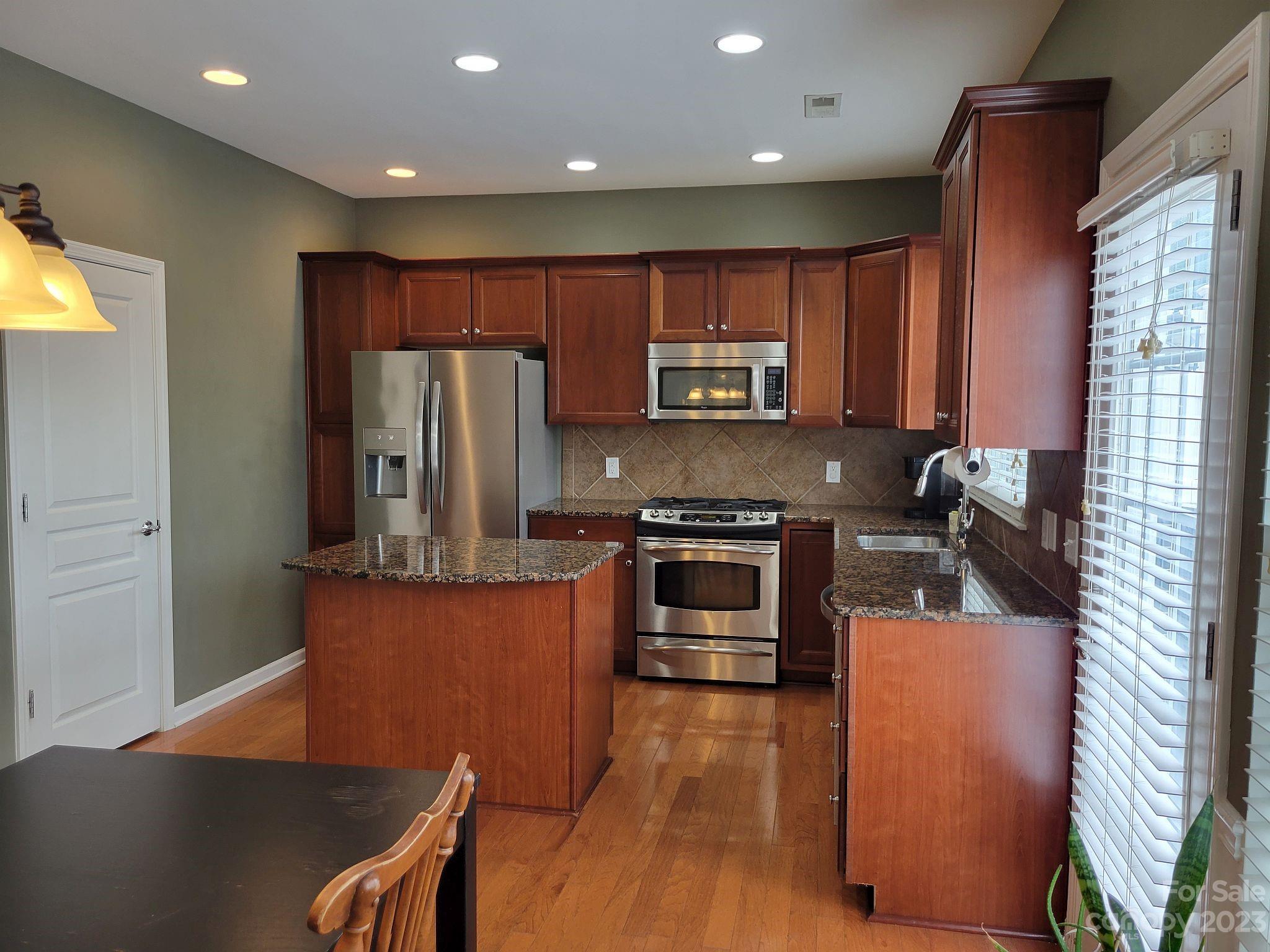 649 6th Baxter Crossing Fort Mill, SC 29708 - Photo 10 of 32 a kitchen with stainless steel appliances granite countertop a refrigerator a stove top oven a sink and dishwasher
