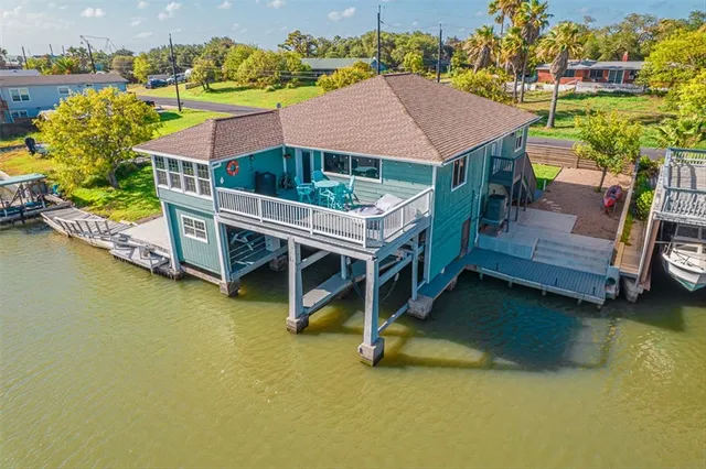 an aerial view of house with yard swimming pool and outdoor seating