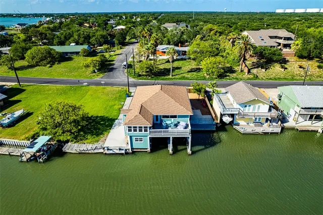 an aerial view of a house with a garden and swimming pool