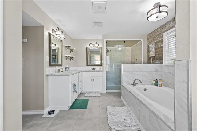a spacious bathroom with a double vanity sink mirror and double