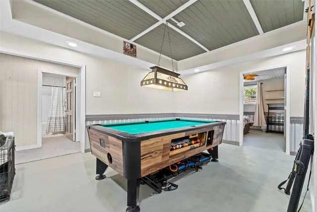 a bed sitting in a room with lawn chairs