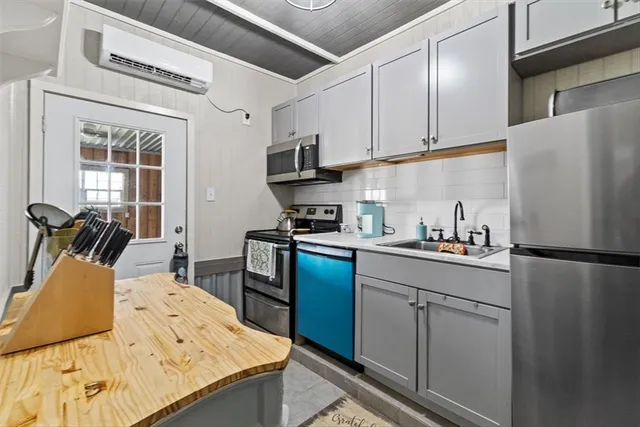 a kitchen with a sink and a stove top oven