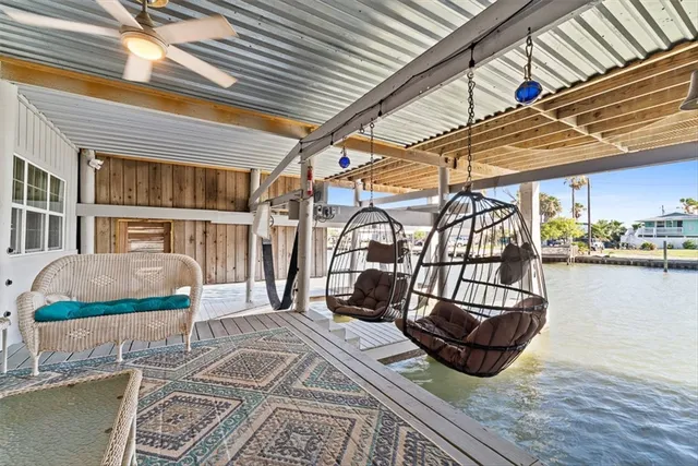 a living room with furniture a fireplace and large windows