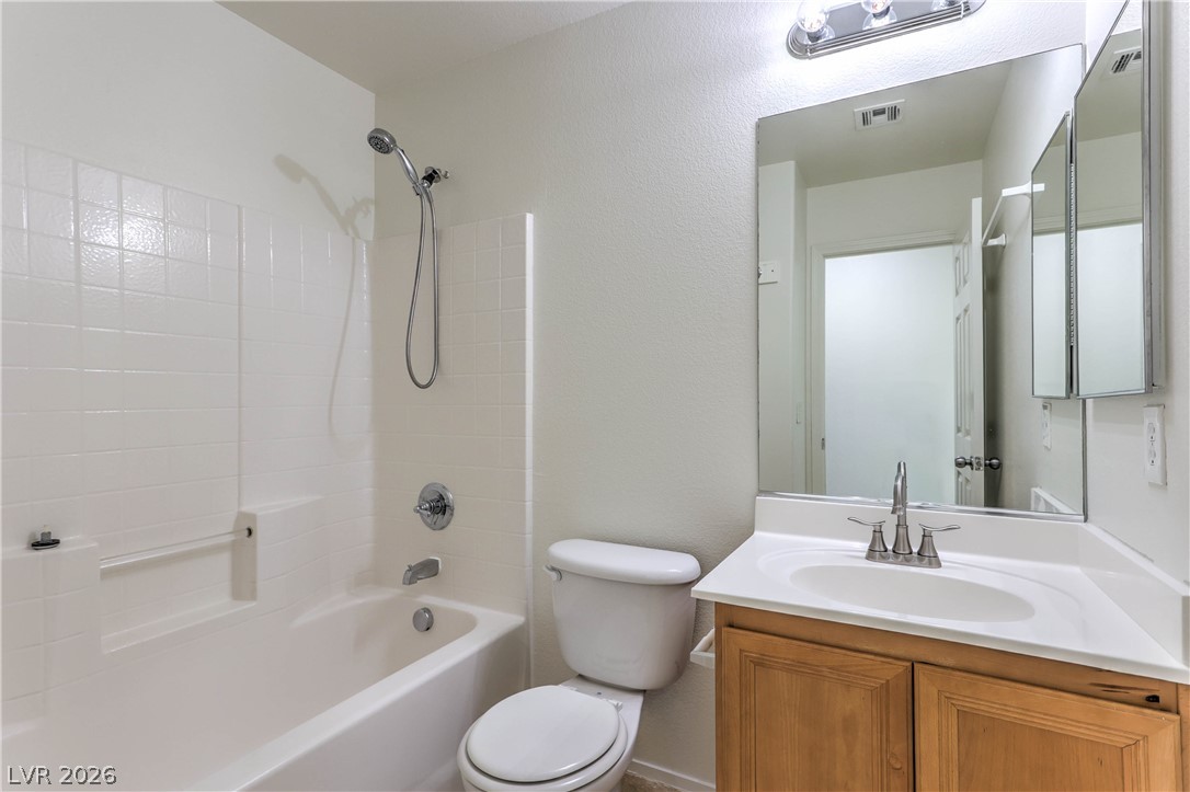 10939 Paradise Road Henderson, NV 89052 - Photo 29 of 36 Functional full bathroom featuring a tub-shower combination, modern vanity, and a large wall mirror.