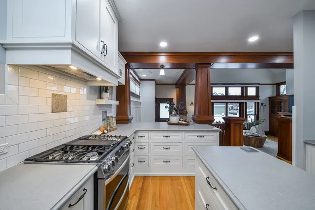 a kitchen with kitchen island a stove a sink and a refrigerator