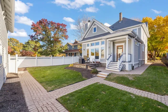 a view of a house with backyard porch and sitting area