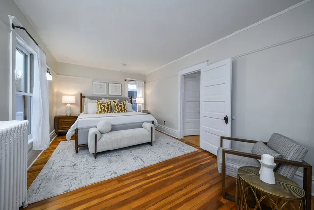 a spacious bedroom with a bed and window