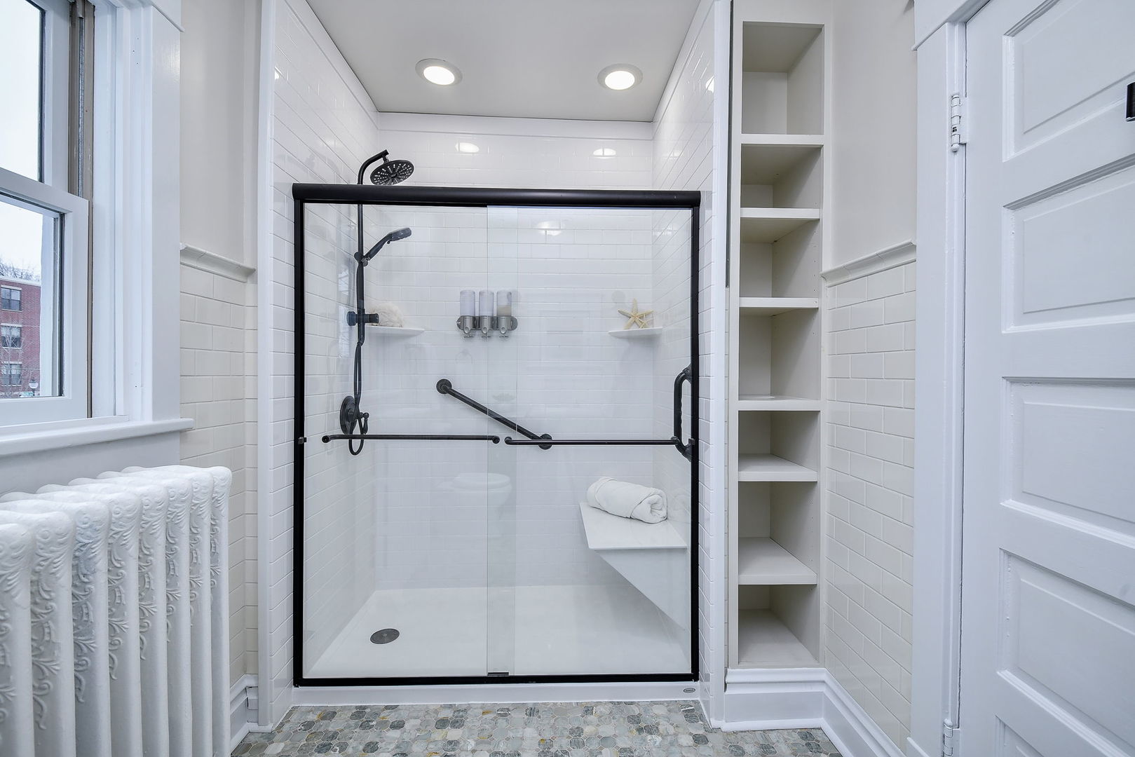 223 North Ellsworth Street Naperville, IL 60540 - Photo 23 of 48 a bathroom with a glass shower door and a sink