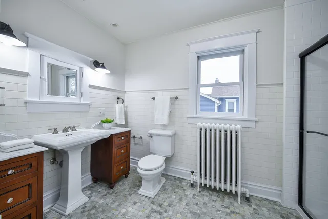 a bathroom with a toilet sink and mirror