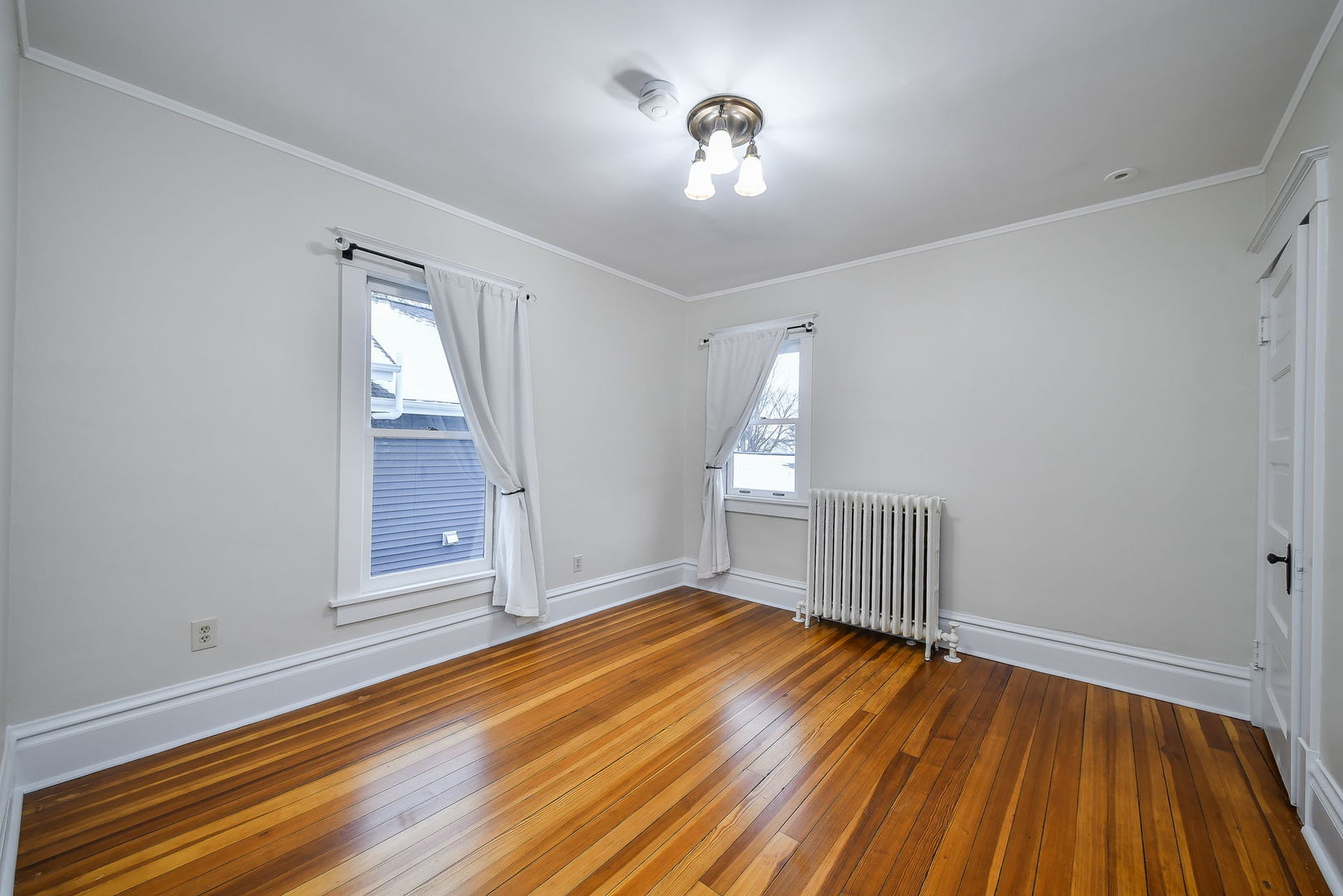 223 North Ellsworth Street Naperville, IL 60540 - Photo 24 of 48 a view of empty room with wooden floor and fan