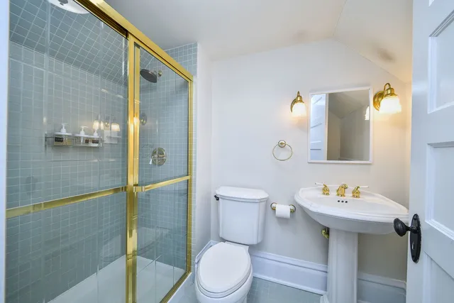 a white toilet sitting next to a bathroom sink