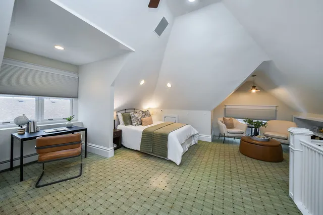 a spacious bedroom with a bed and a couch