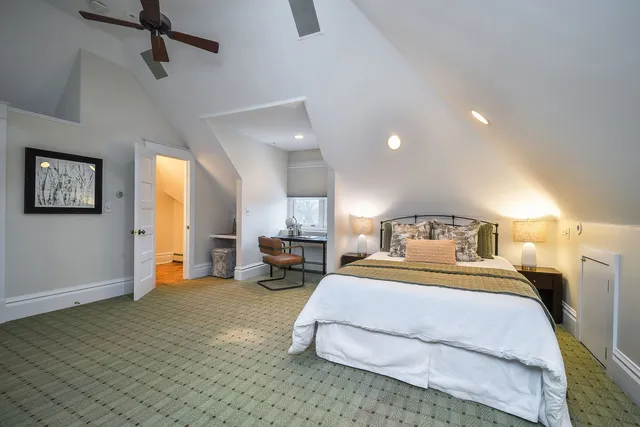 a spacious bedroom with a bed a couch and a dresser