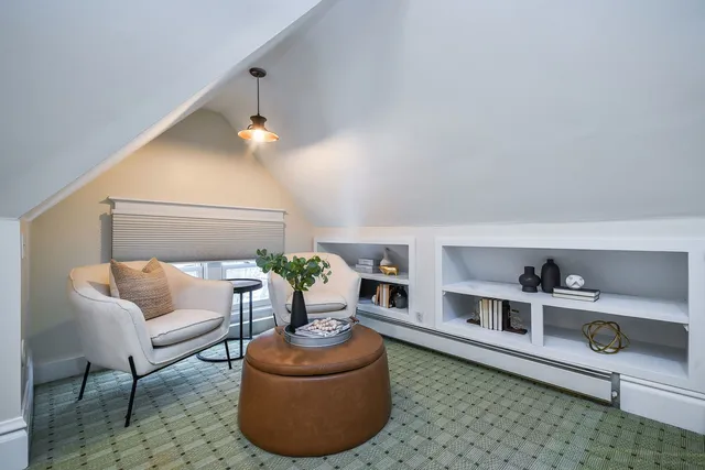a living room with furniture and a lamp