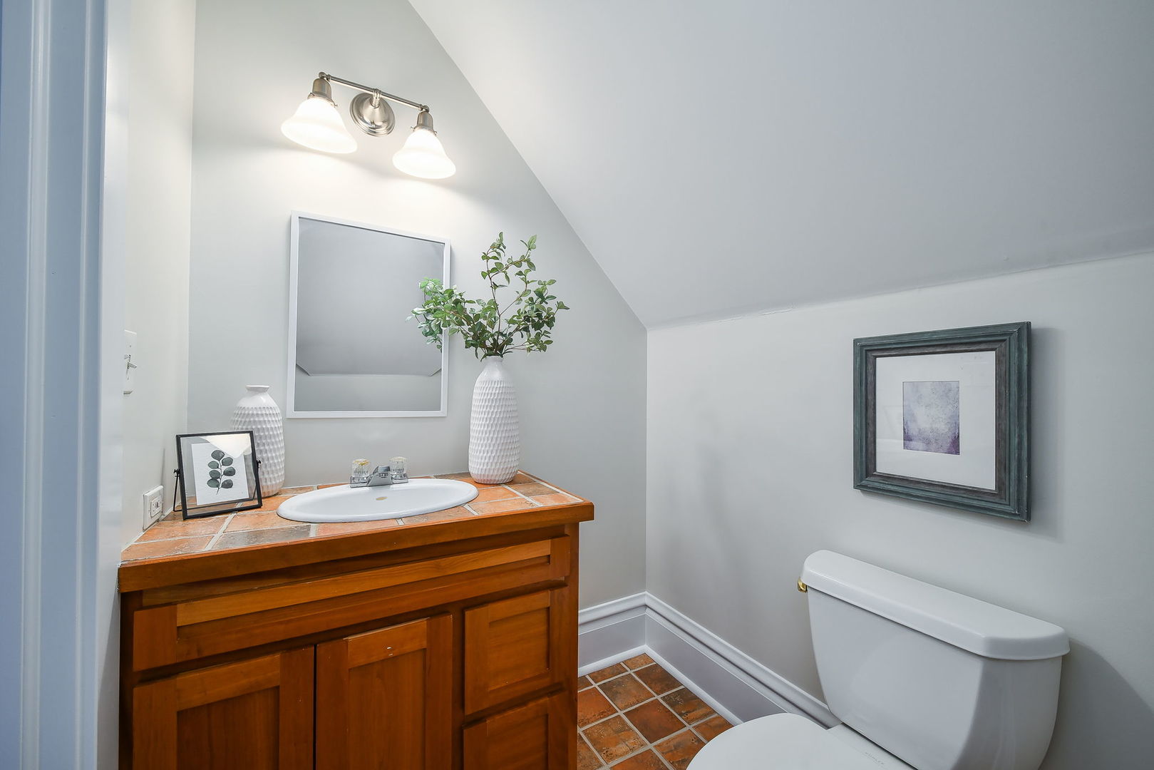 223 North Ellsworth Street Naperville, IL 60540 - Photo 30 of 48 a bathroom with a sink a toilet and mirror