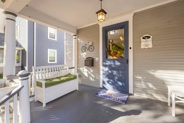 a view of a porch with furniture and floor to ceiling window