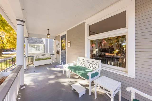 a view of a porch with furniture and floor to ceiling window