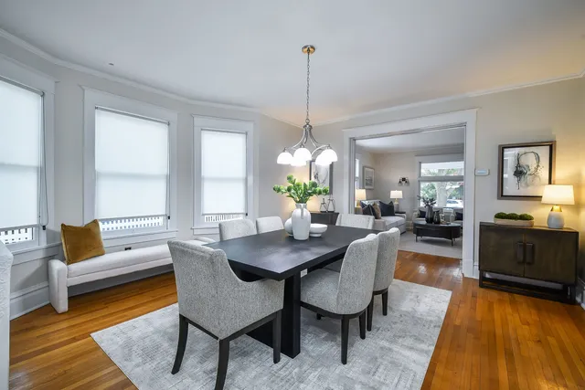 a living room with furniture dining table and a chandelier