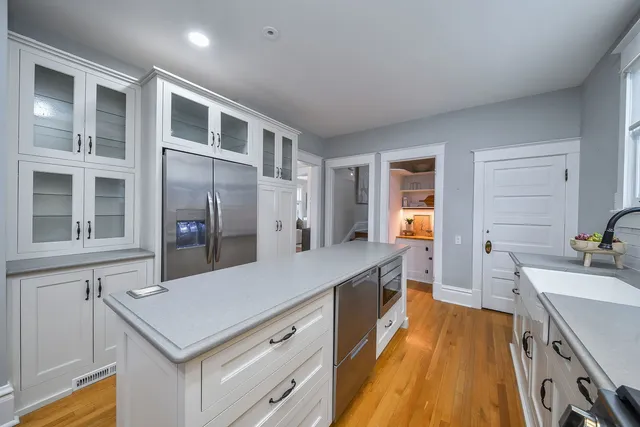 a kitchen with stainless steel appliances a sink and a refrigerator