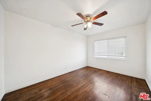 a view of a big room with wooden floor closet and windows