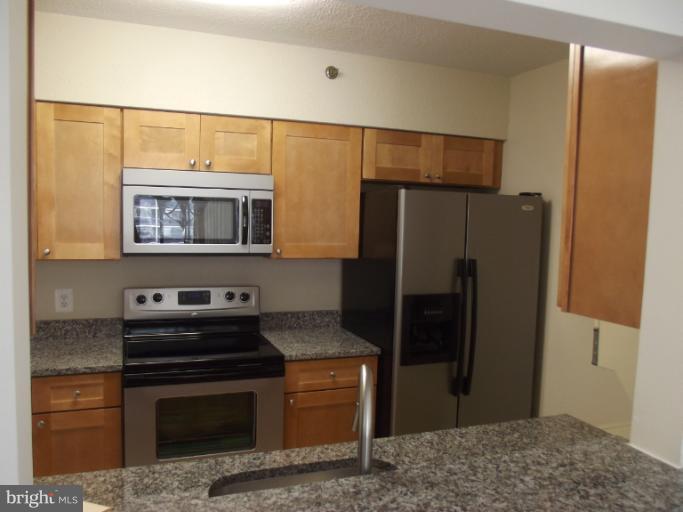 5505 Seminary Road, Unit 802N Falls Church, VA 22041 - Photo 1 of 12 a kitchen with stainless steel appliances granite countertop a refrigerator and a sink