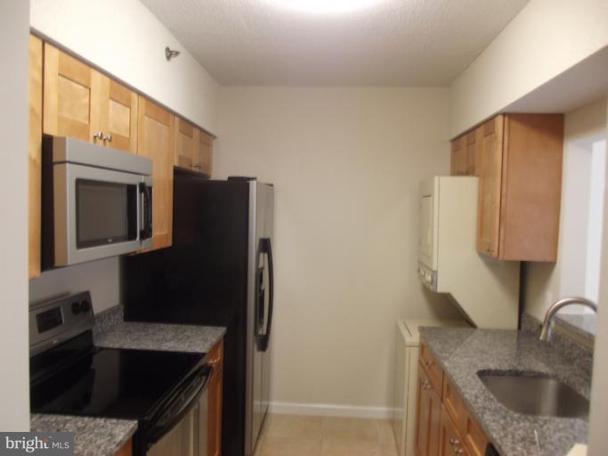 5505 Seminary Road, Unit 802N Falls Church, VA 22041 - Photo 5 of 12 a kitchen with granite countertop a refrigerator and a sink