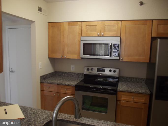 5505 Seminary Road, Unit 802N Falls Church, VA 22041 - Photo 9 of 12 a kitchen with a stove and a microwave
