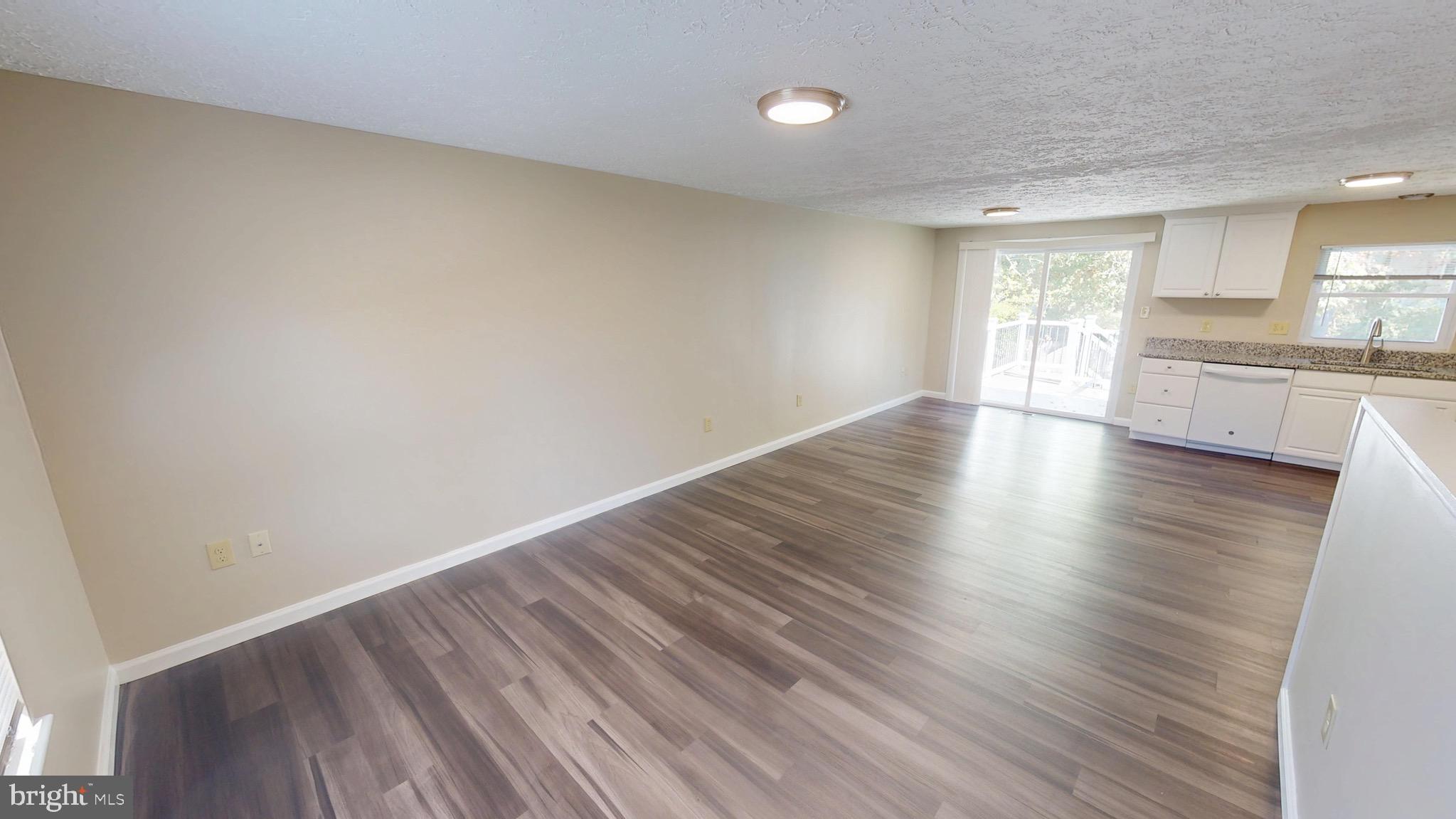 12820 Twin Oak Drive Waldorf, MD 20601 - Photo 15 of 98 a view of a kitchen with wooden floor and a window