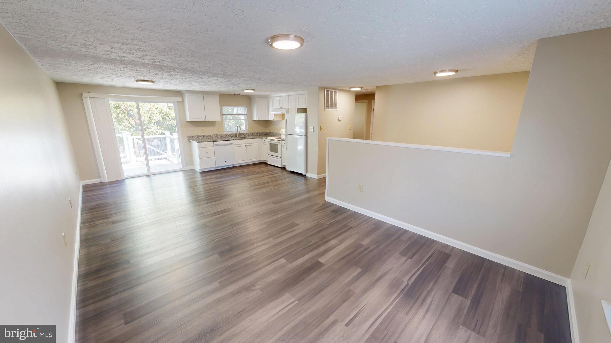 12820 Twin Oak Drive Waldorf, MD 20601 - Photo 16 of 98 a view of an empty room with wooden floor and a window