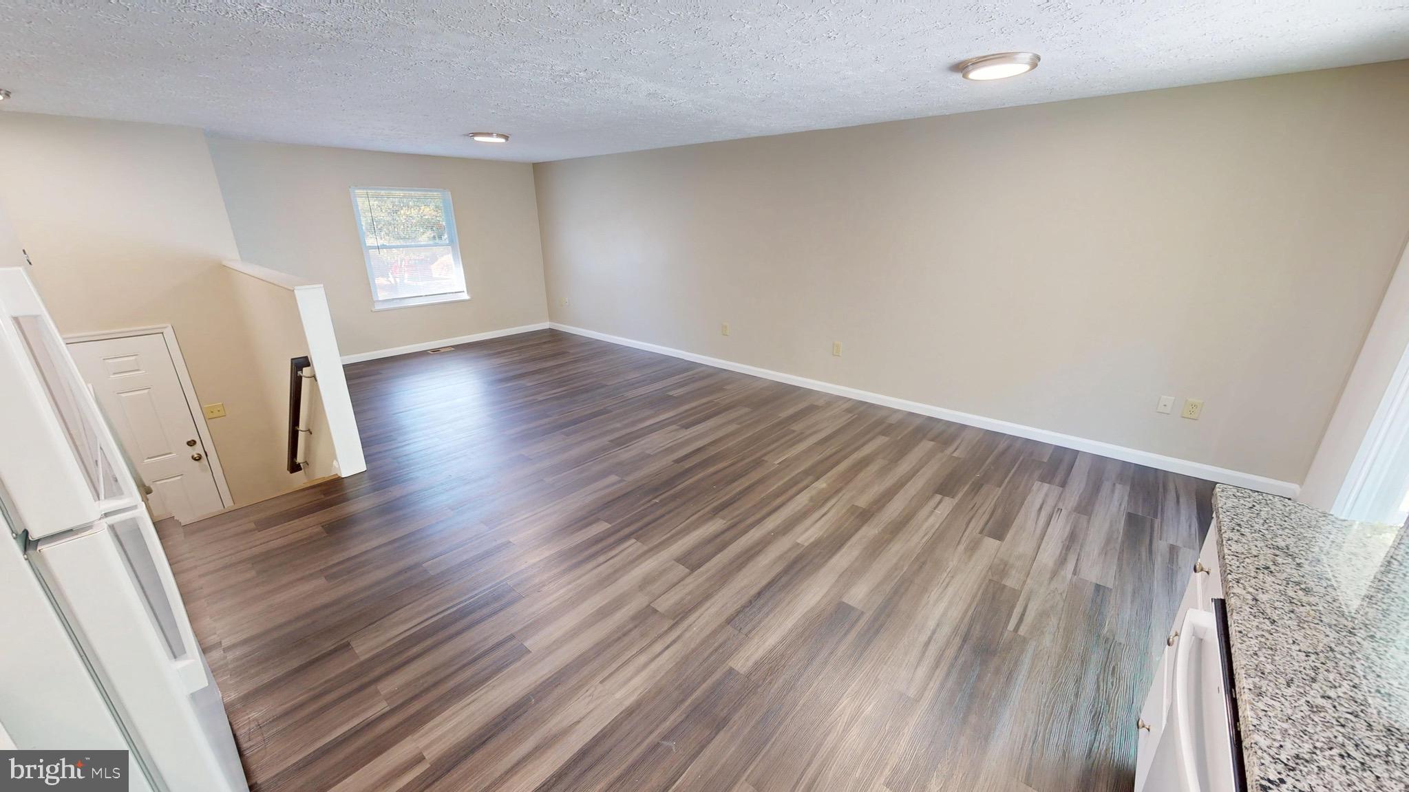 12820 Twin Oak Drive Waldorf, MD 20601 - Photo 20 of 98 an empty room with wooden floor and windows