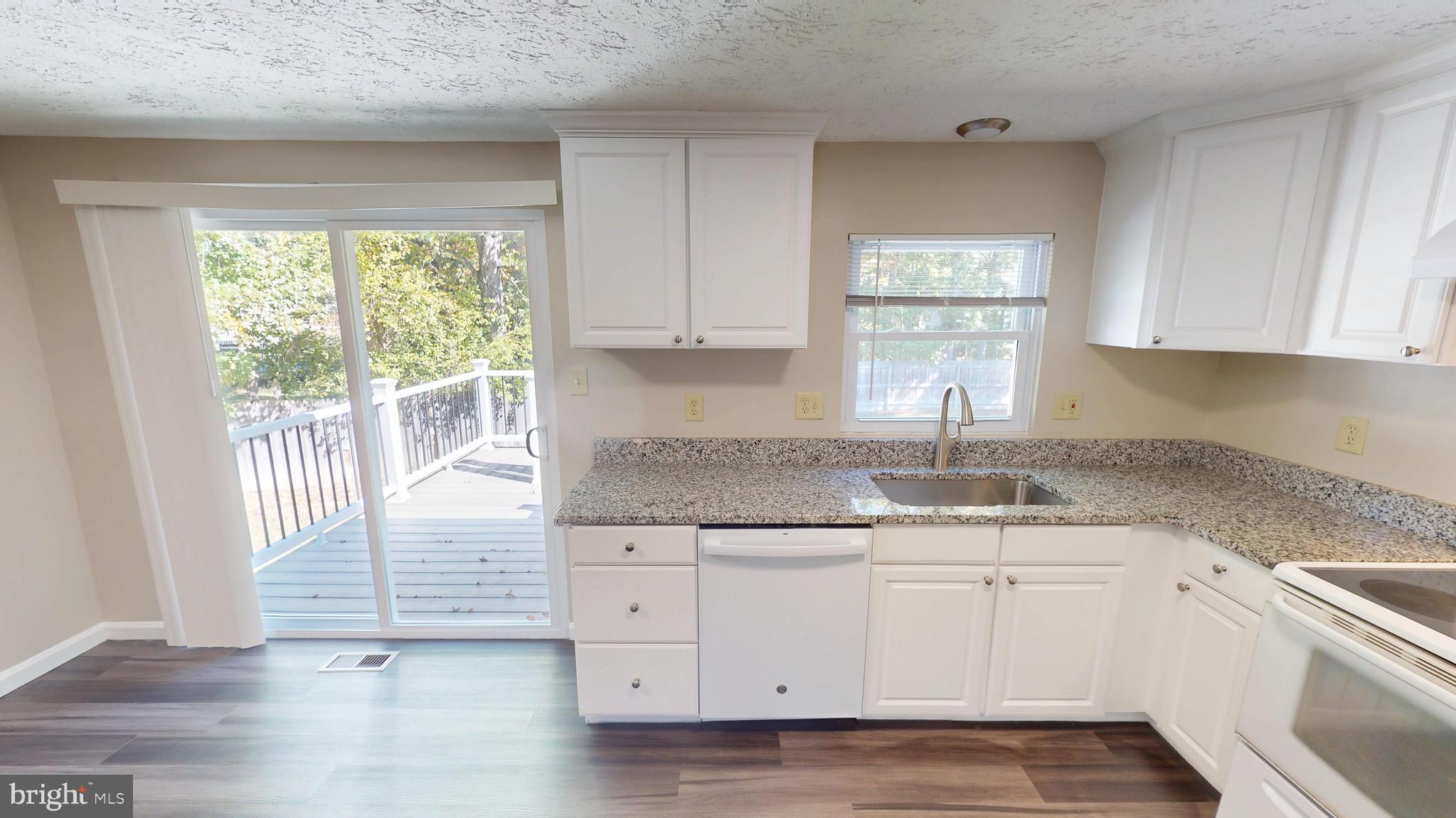 12820 Twin Oak Drive Waldorf, MD 20601 - Photo 22 of 98 a kitchen with granite countertop a sink window and cabinets
