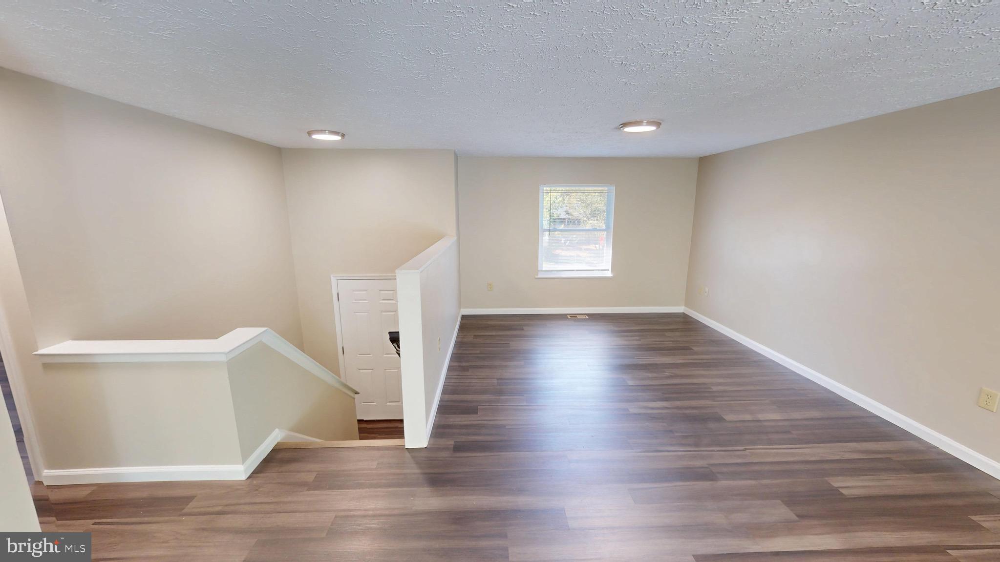 12820 Twin Oak Drive Waldorf, MD 20601 - Photo 23 of 98 a view of an empty room with wooden floor and a window
