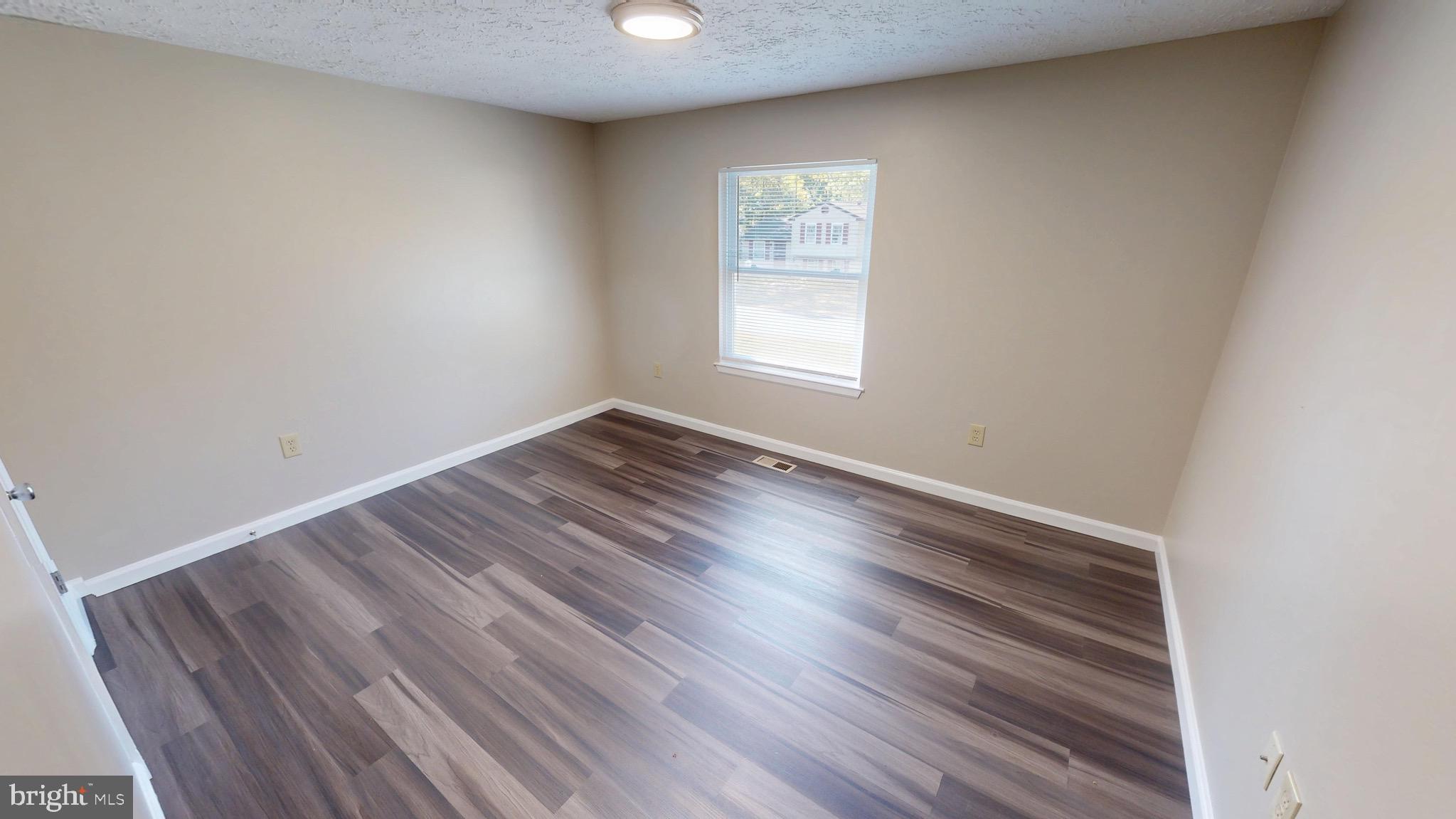 12820 Twin Oak Drive Waldorf, MD 20601 - Photo 26 of 98 an empty room with wooden floor and windows