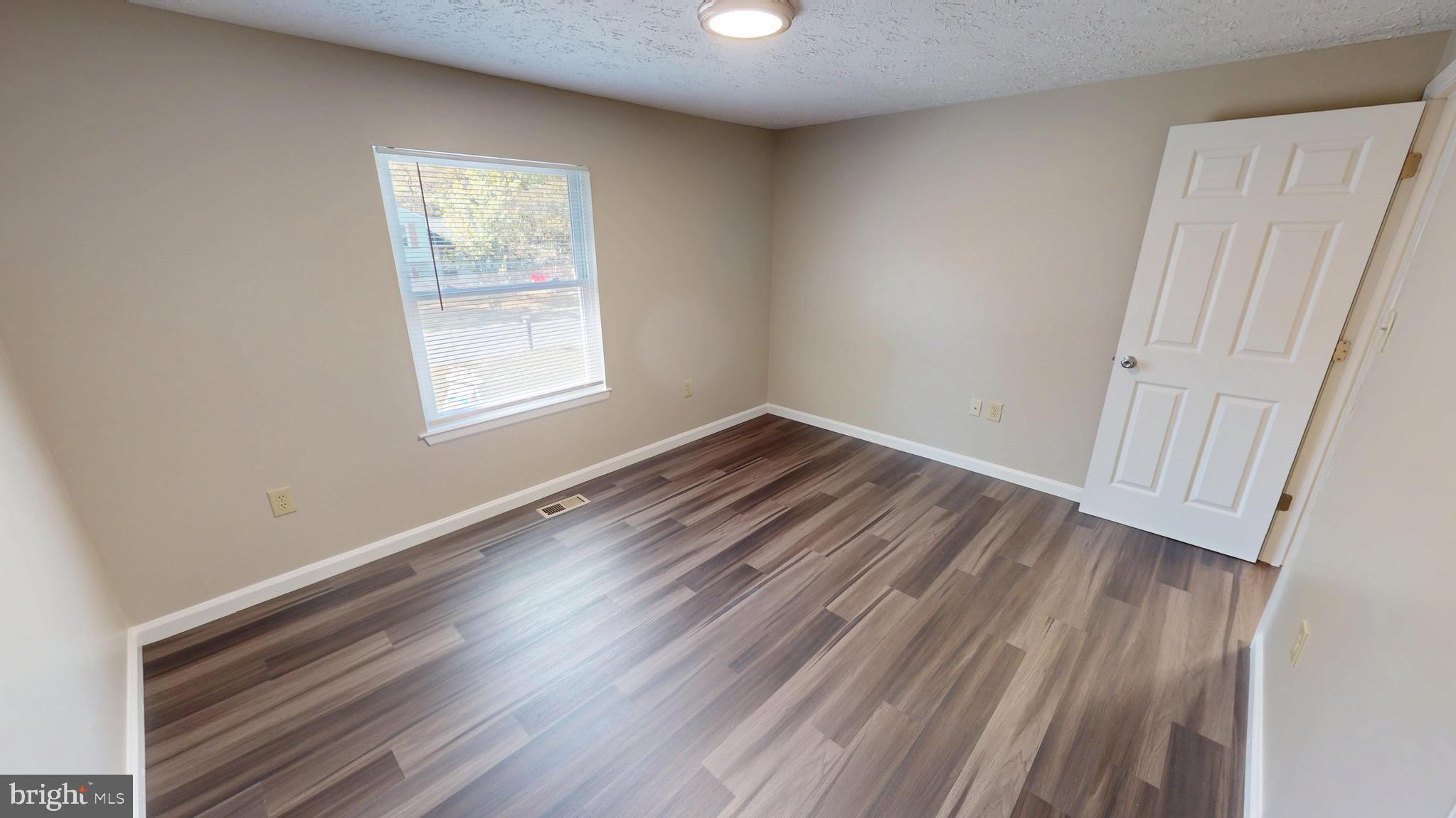 12820 Twin Oak Drive Waldorf, MD 20601 - Photo 27 of 98 wooden floor in an empty room with a window